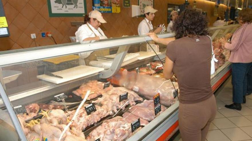 Consumidores compran  carne  en la carnicería de un supermercado. | lp / dlp