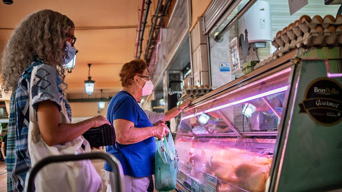 Una mujer compra en una carnicería del Mercado Nuestra Señora de África de Santa Cruz de Tenerife. | | ANDRÉS GUTIÉRREZ