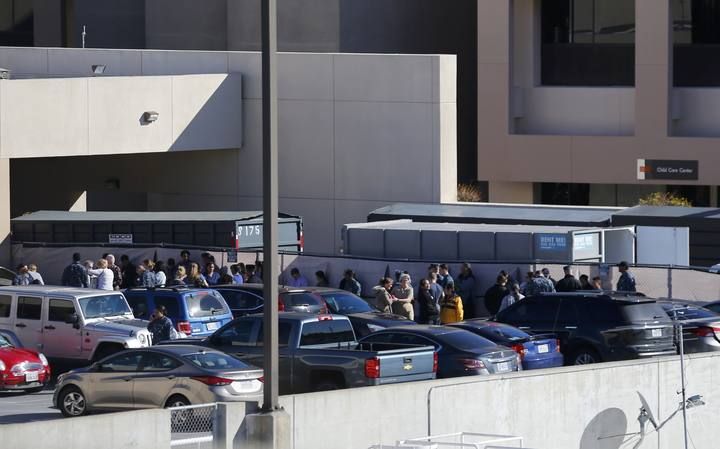 People are evacuated from a building at the Naval Medical Center in San Diego