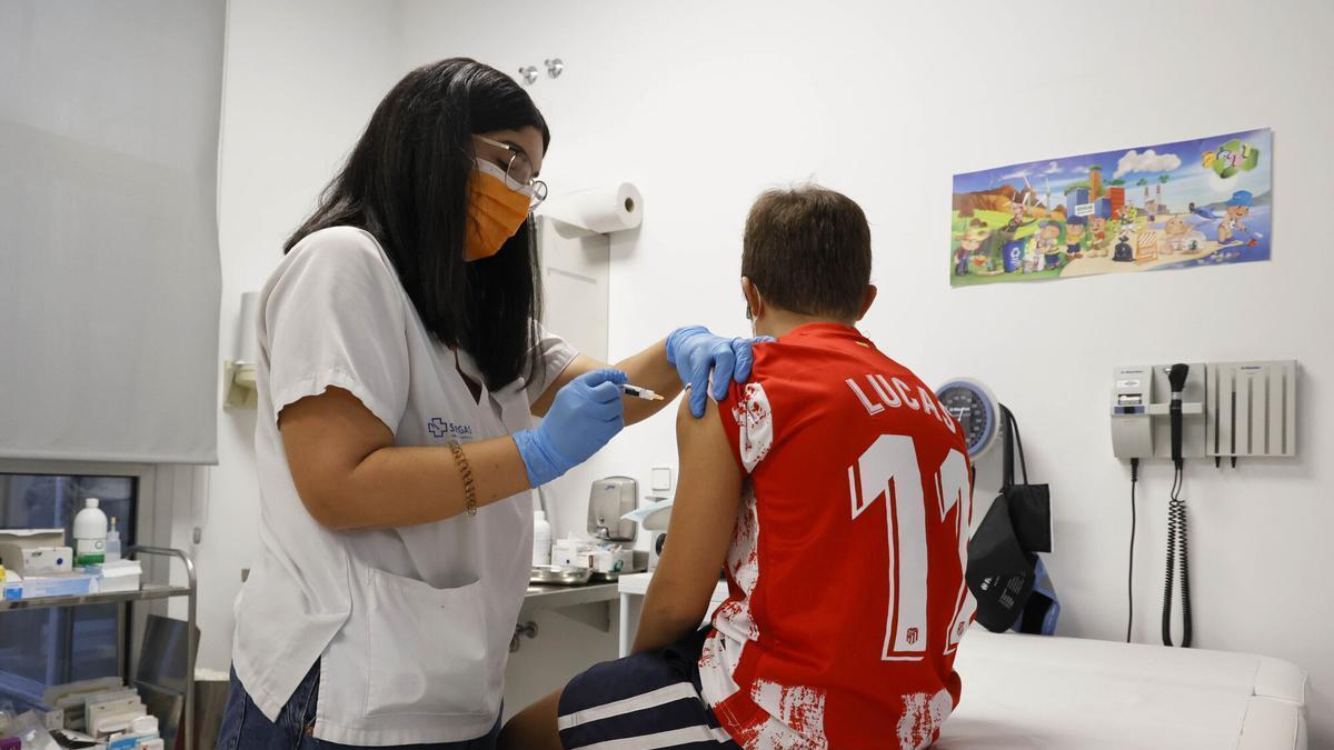 Una enfermera de pediatría pone la vacuna del virus del papiloma humano a un niño.