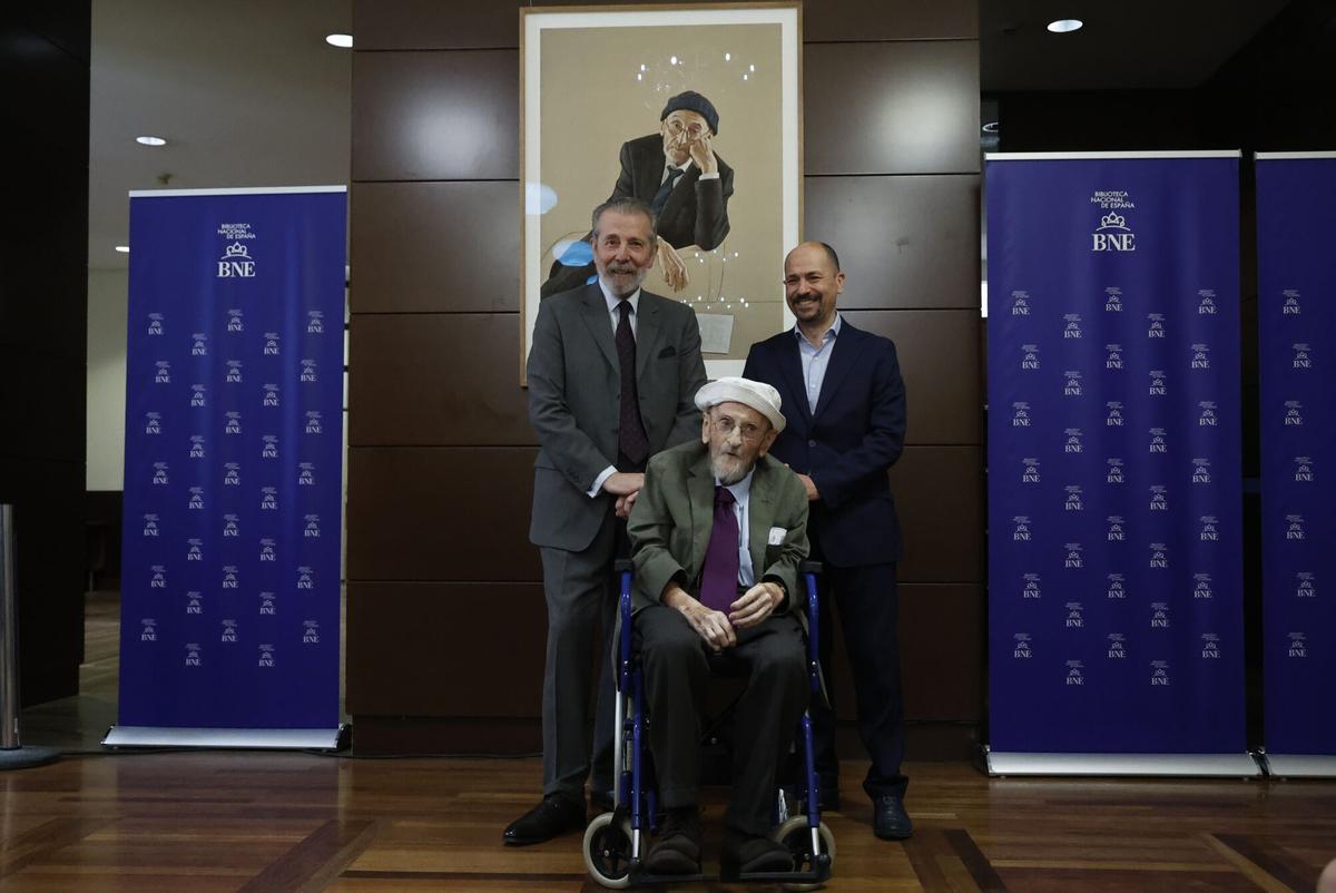 MADRID, 09/07/2026.- El artista Hernán Cortés (i) y el director de la Biblioteca Nacional, Óscar Arroyo (d), posan junto al escritor Álvaro Pombo durante el acto de presentación del retrato del Premio Cervantes 2024 en la Biblioteca Nacional, dentro de la Galería de Retratos de los galardonados con ese premio, este jueves. EFE/ Maria Aguilella Pardo