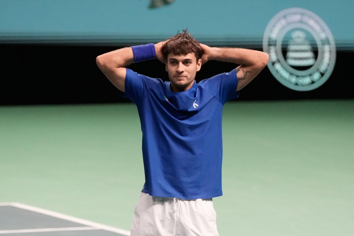 Italy's Flavio Cobolli celebrates after winning a Davis Cup final singles tennis match against Spain's Jaume Munar, in Bologna, Italy, Sunday, Nov. 23, 2025. (AP Photo/Luca Bruno)