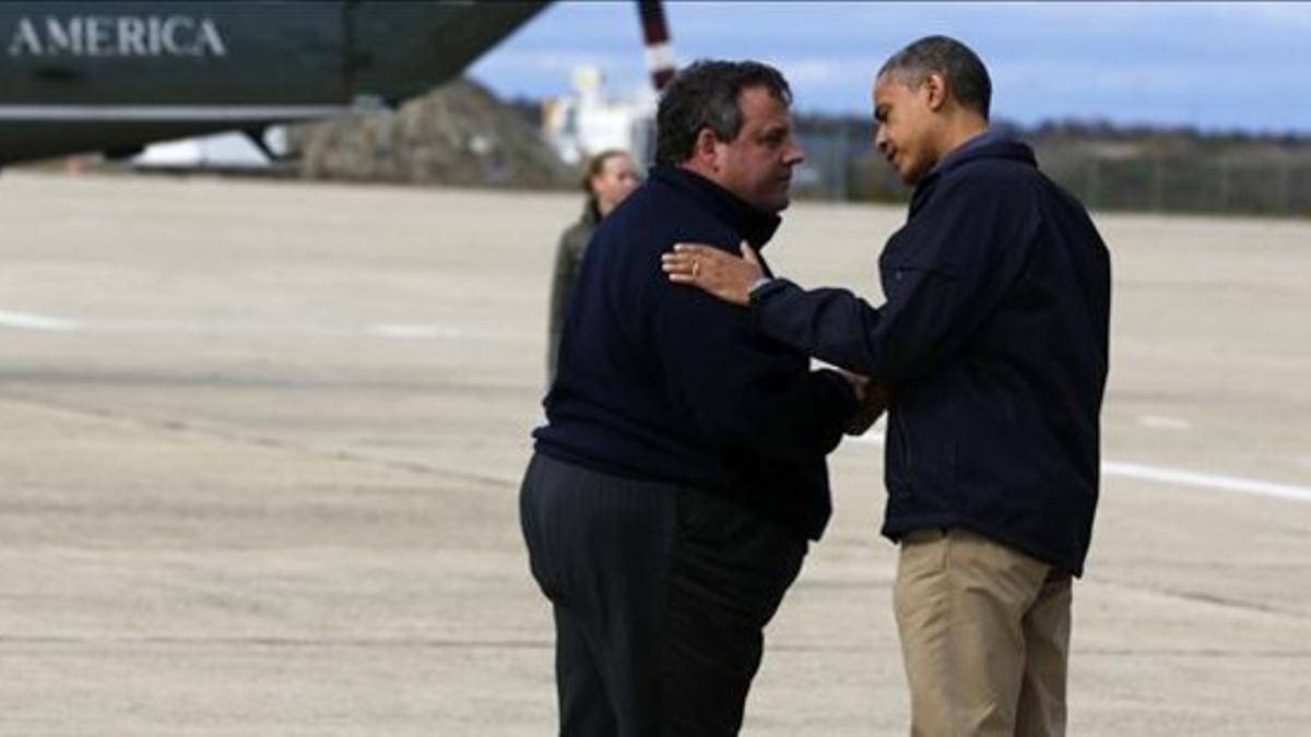 Obama saluda al gobernador de Nueva Jersey tras aterrizar.