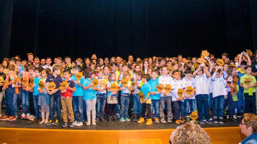 Numeroso grupo de deportistas con sus trofeos en el escenario del Auditorio de Teror.