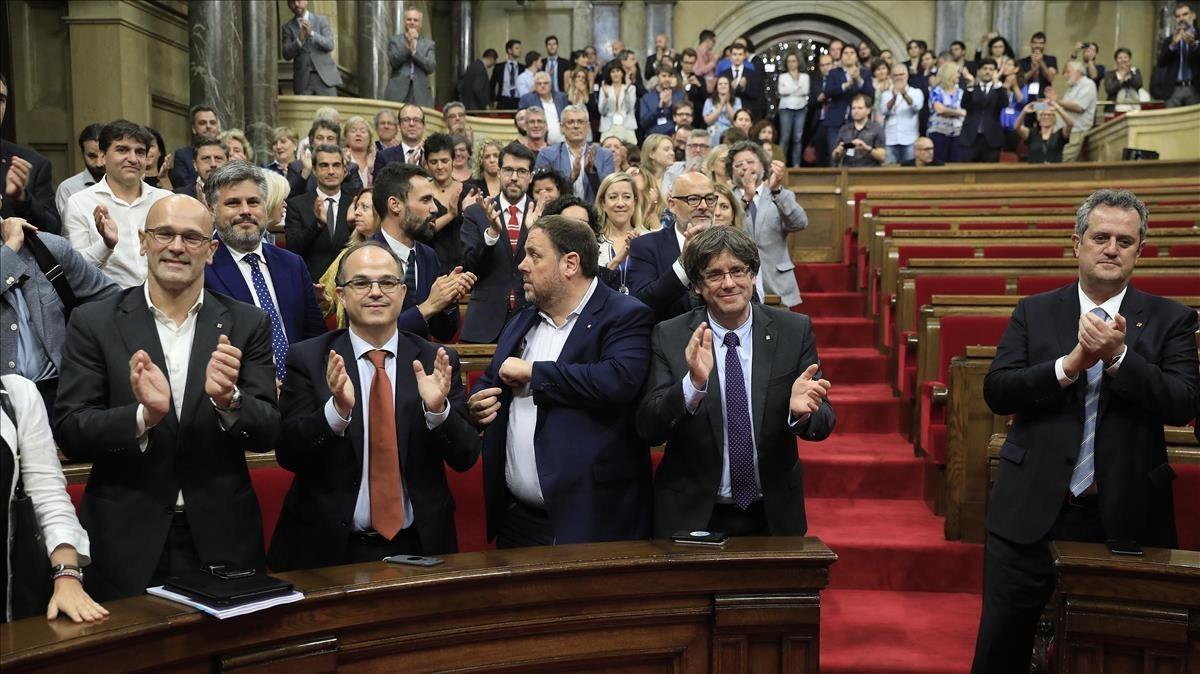 Los diputados de Junts pel Sí y la CUP, además del Govern, aplauden tras la aprobación de la ley de transitoriedad.