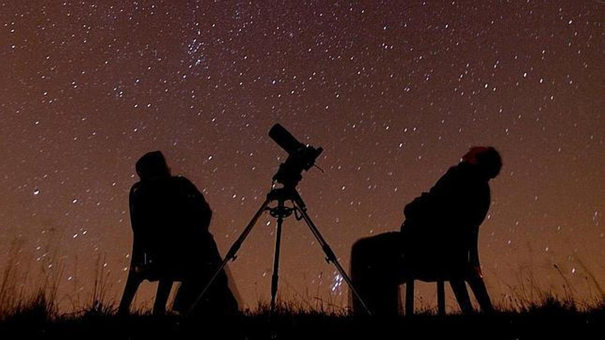 Dos personas observan el cielo estrellado.