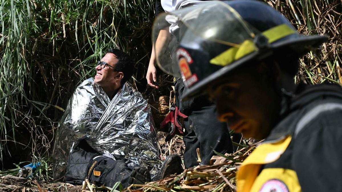 Integrantes de organismos de socorro trabajan en la zona del accidente de un autobús, que cayó en un río de aguas residuales en la Ciudad de Guatemal