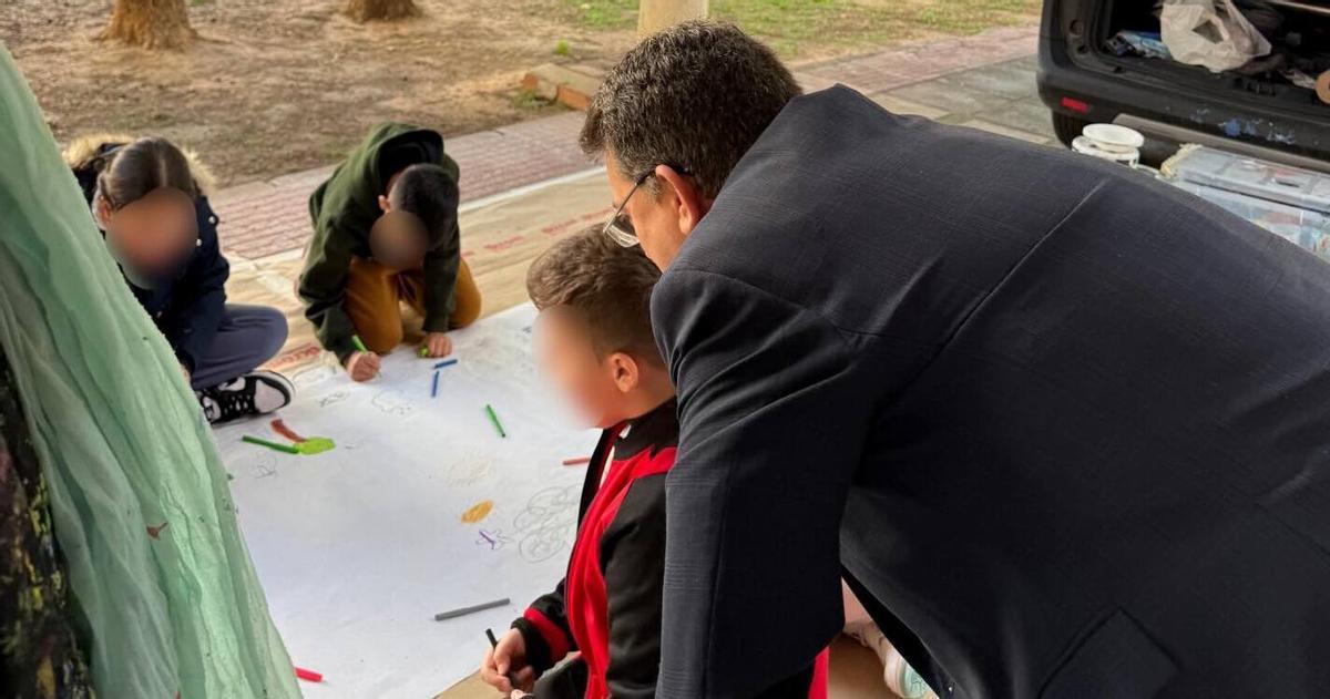 El alcalde ayuda a un joven a realizar un mural en una actividad educativa de Alfafar.