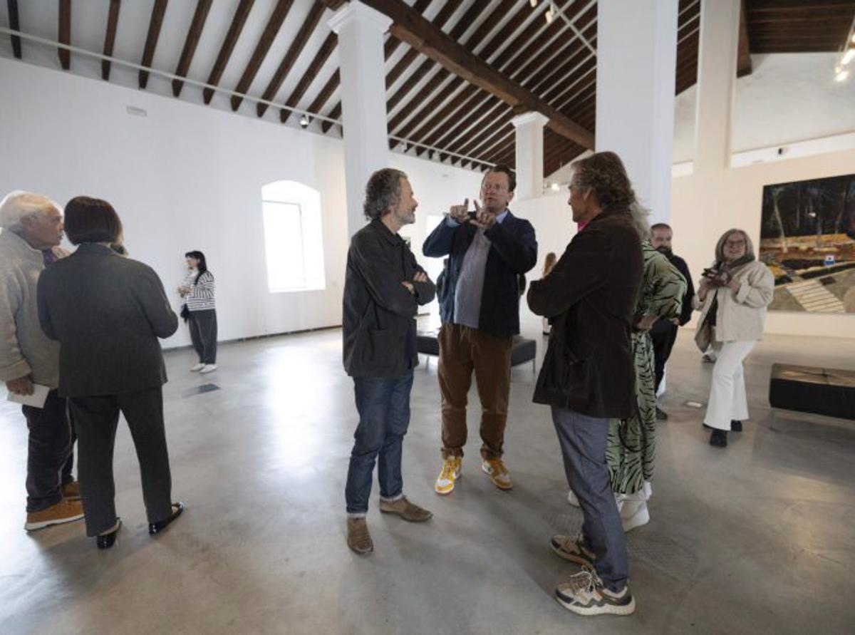 Mackinnon conversa con dos visitantes. | V. MARÍ