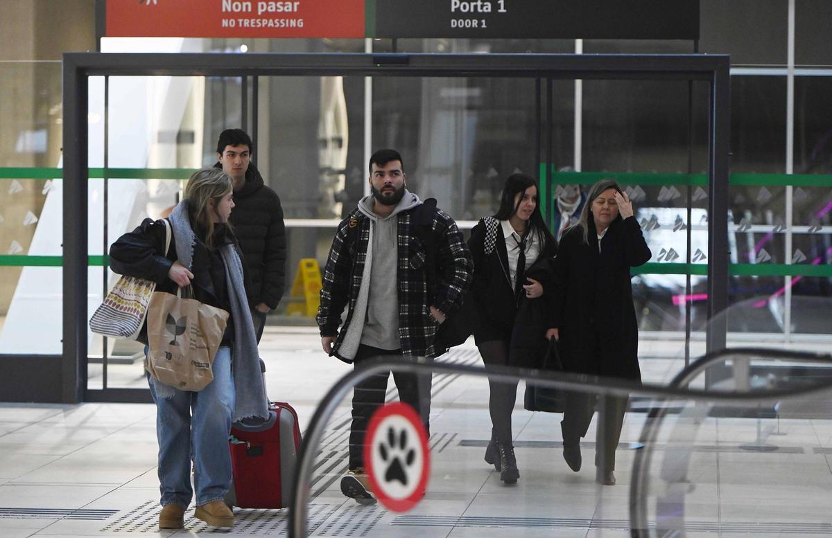 Viajeros en uno de los primeros trenes del Eje Atlántico a su llegada a Urzáiz este domingo.