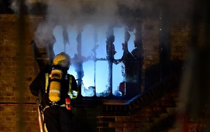 A firefighter tackles a fire at Camden Market in ...