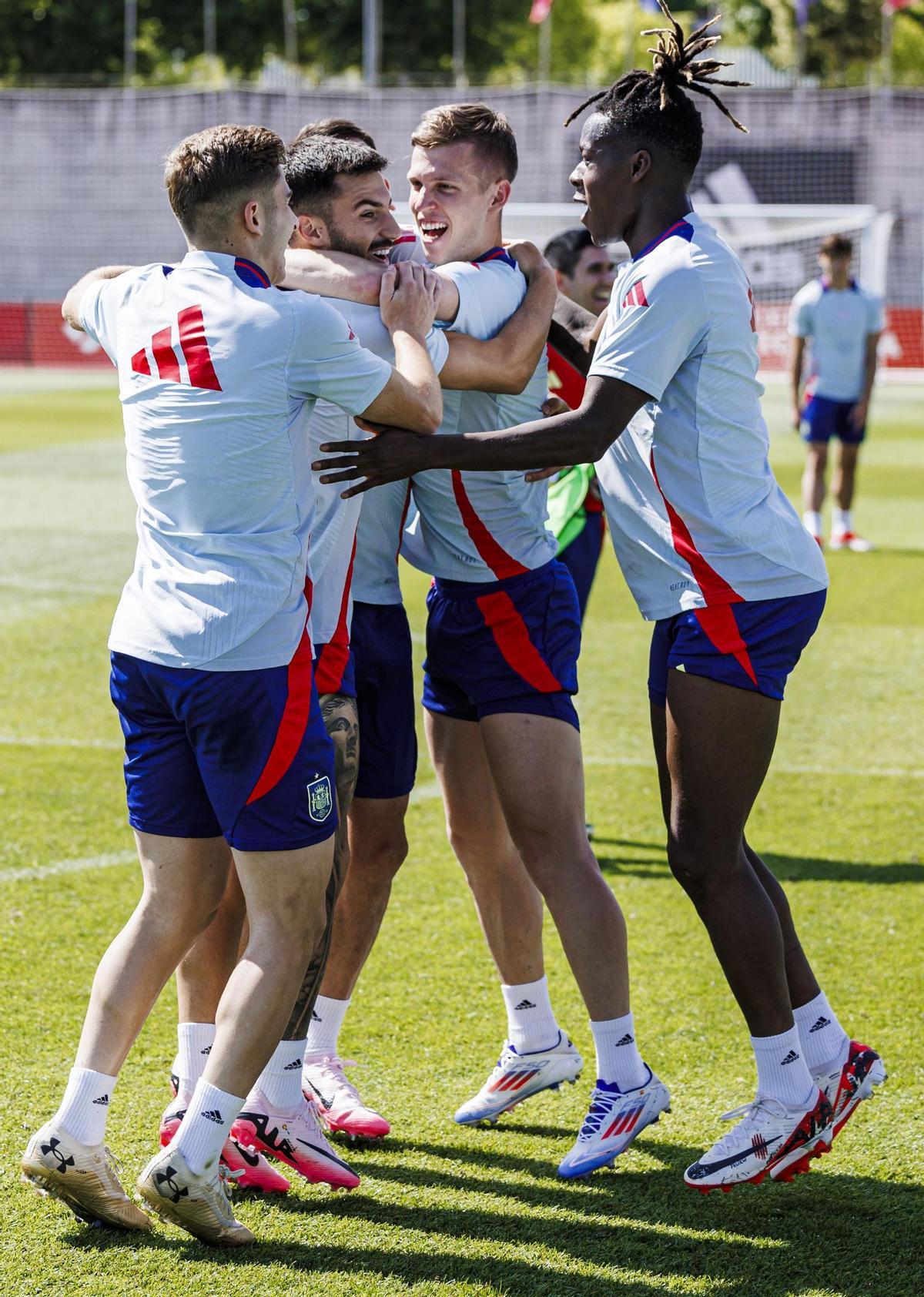 Álex Baena (2º por izquierda) es abrazado por Olmo y Nico en un entrenamiento de la selección española.