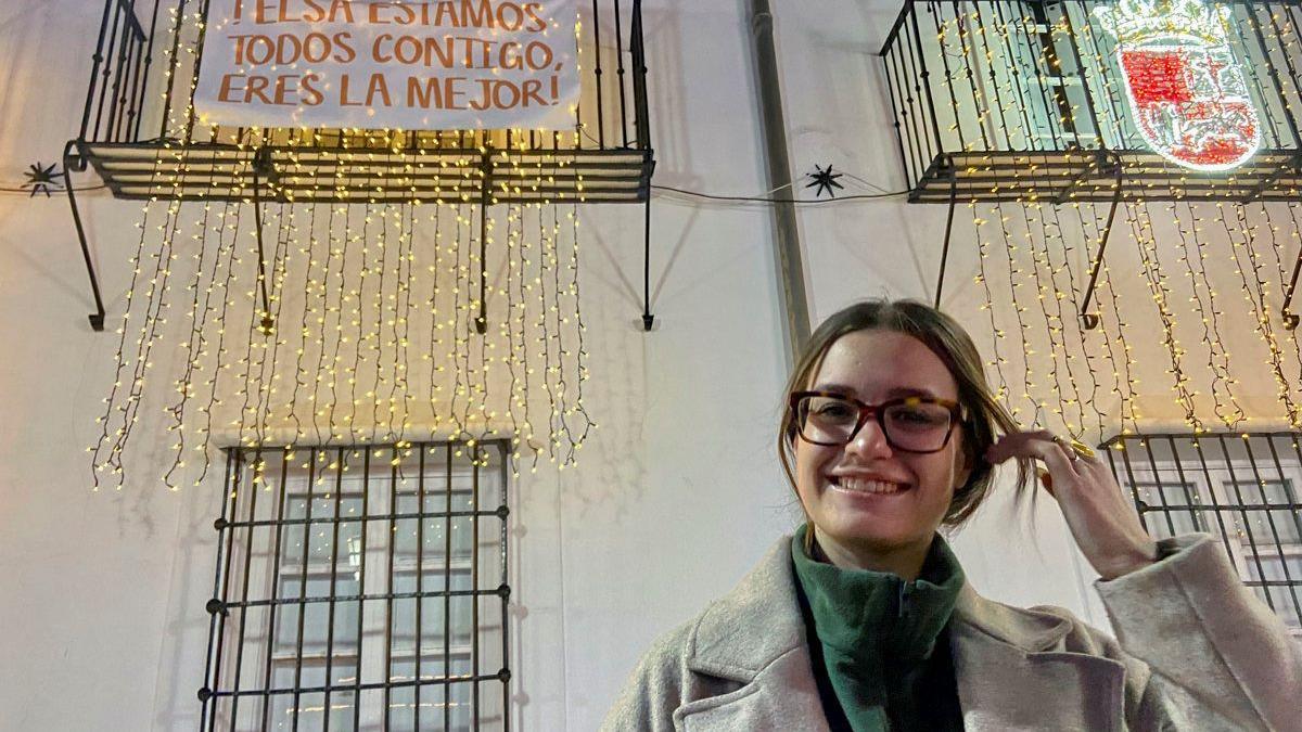 Elsa Tortonda en su pueblo con una pancarta de apoyo.