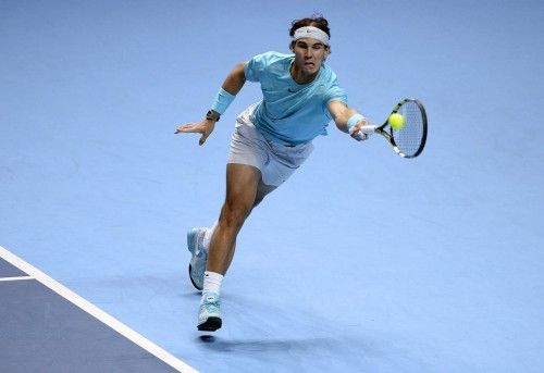 Rafael Nadal of Spain hits a return to Roger Federer of Switzerland during their men's singles semi-final ennis match in London