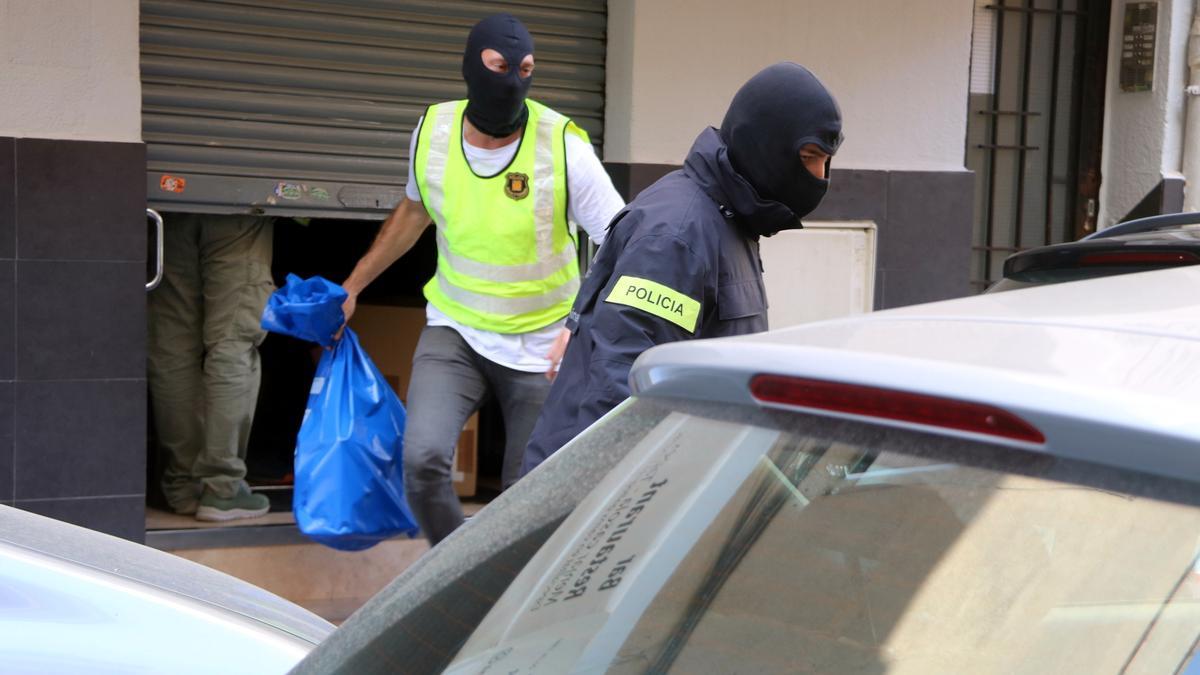 Agents dels Mossos d&#039;Esquadra sortint carregats de bosses d&#039;un bar de Gavà on s&#039;ha realitzat un escorcoll
