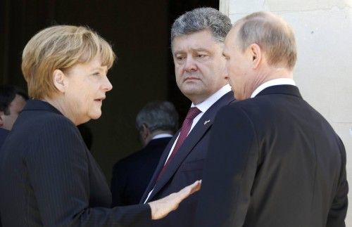 Ukraine president-elect Poroshenko looks on as German Chancellor Merkel talks to Russian President Putin after a group photo for the 70th anniversary of the D-Day landings at Benouville Castle