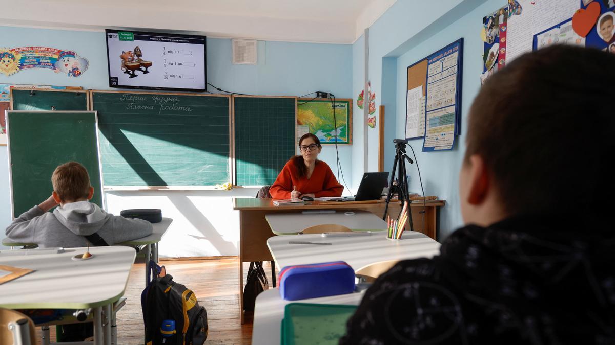 Teacher conducts a hybrid mathematic lesson for junior students of a private school in Kyiv