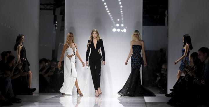 Models present creations by Italian designer Donatella Versace as part of her Haute Couture Spring/Summer 2016 fashion show for Atelier Versace in Paris