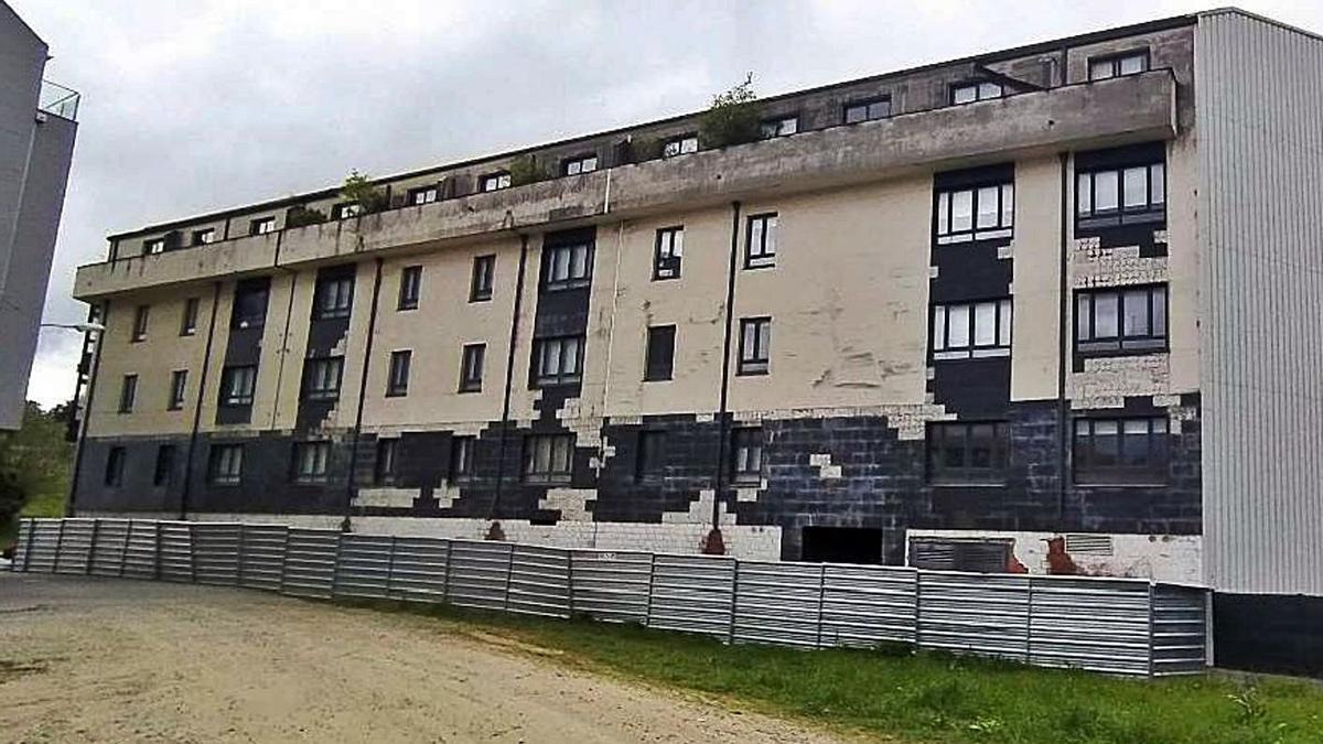 Fachada del edificio, con losetas caída, y valla instalada por el Ayuntamiento. |   // LA OPINIÓN