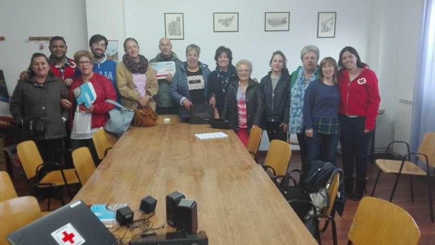 Asistentes a uno de los cursos en una fotografía grupal junto a miembros de Cruz Roja.