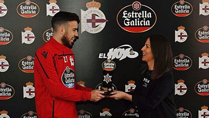 Expósito recibe de María Buján, de cervecería El Hoyo, el premio al Jugador Estrella Galicia de febrero.