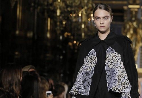 Model Cara Delevingne presents a creation by British designer Stella McCartney as part of her Spring/Summer 2015 women's ready-to-wear collection during Paris Fashion Week