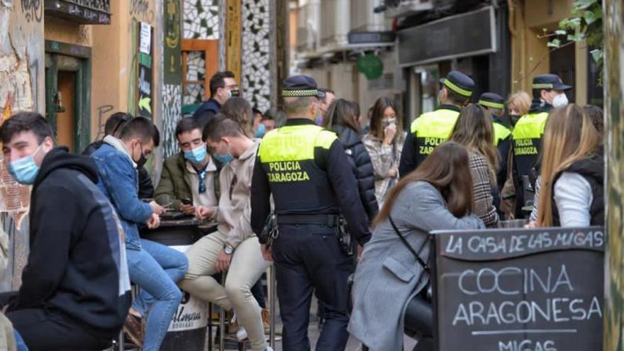 Varios agentes de la Policía Local de Zaragoza comprobando que se respetan las distancias entre las mesas.  | EL PERIÓDICO