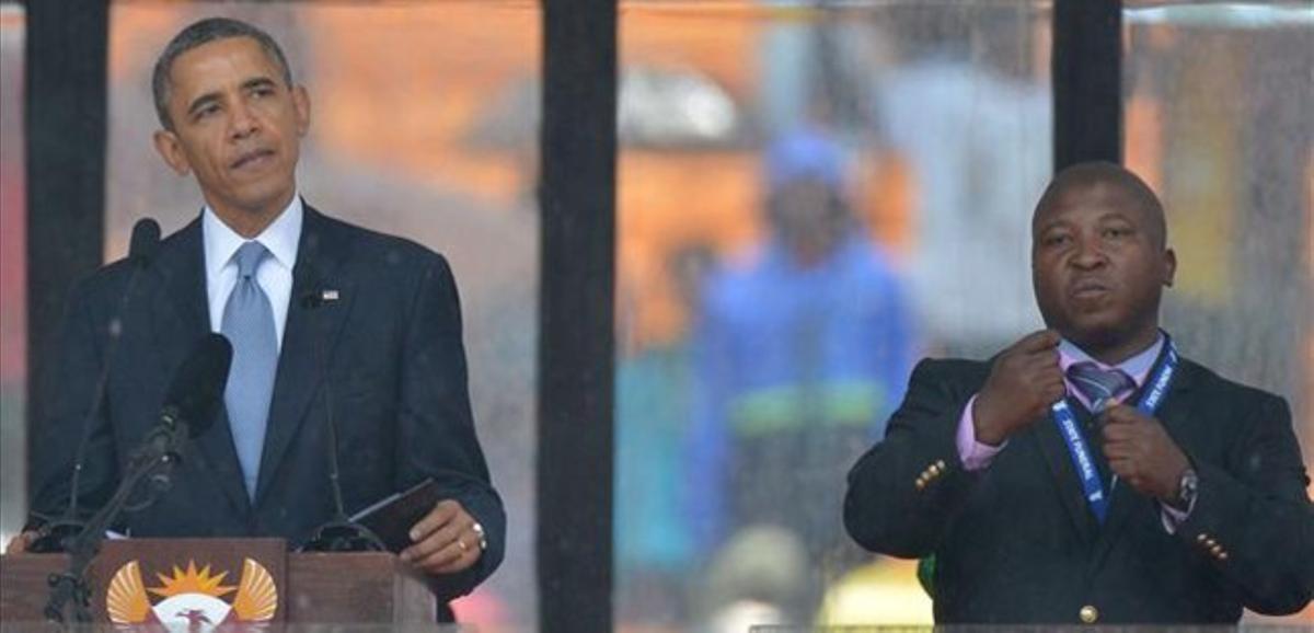Obama al costat del fals intèrpret de la llengua de signes, a l’escenari de l’estadi de Soweto, aquest dimarts. Obama al costat del fals intèrpret de la llengua de signes, a l’escenari de l’estadi de Soweto, aquest dimarts.
