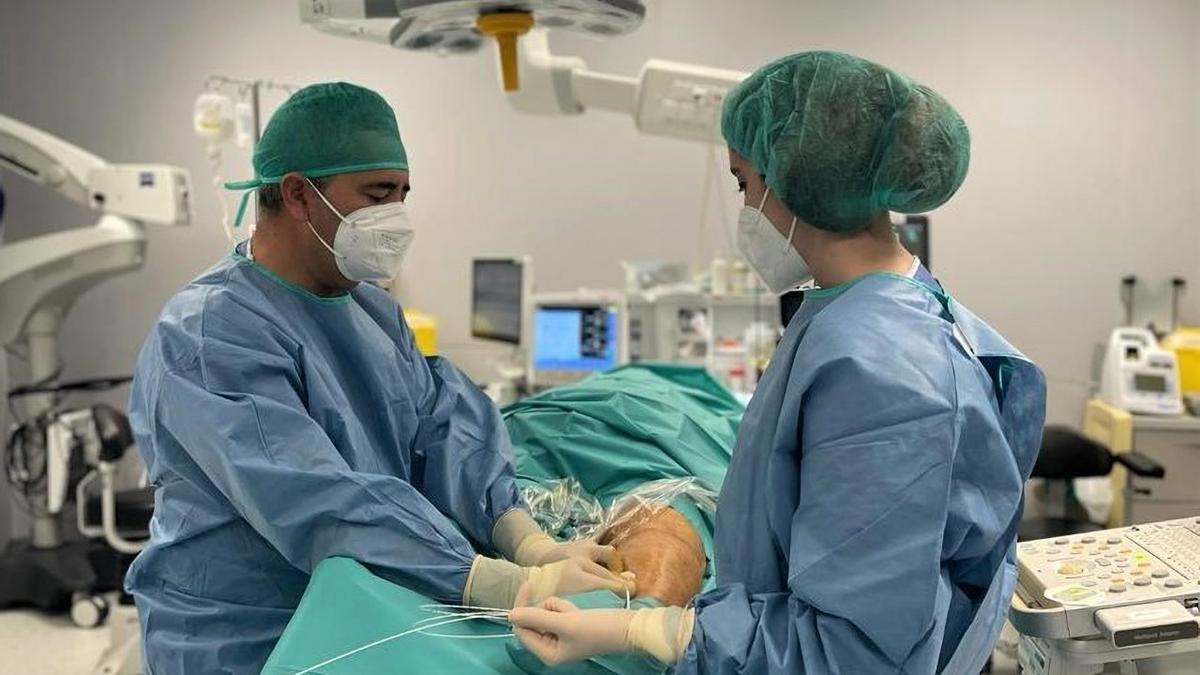 El doctor Manuel Sánchez Maestre, junto a otra compañera, en un quirófano del hospital QuirónSalud Córdoba.