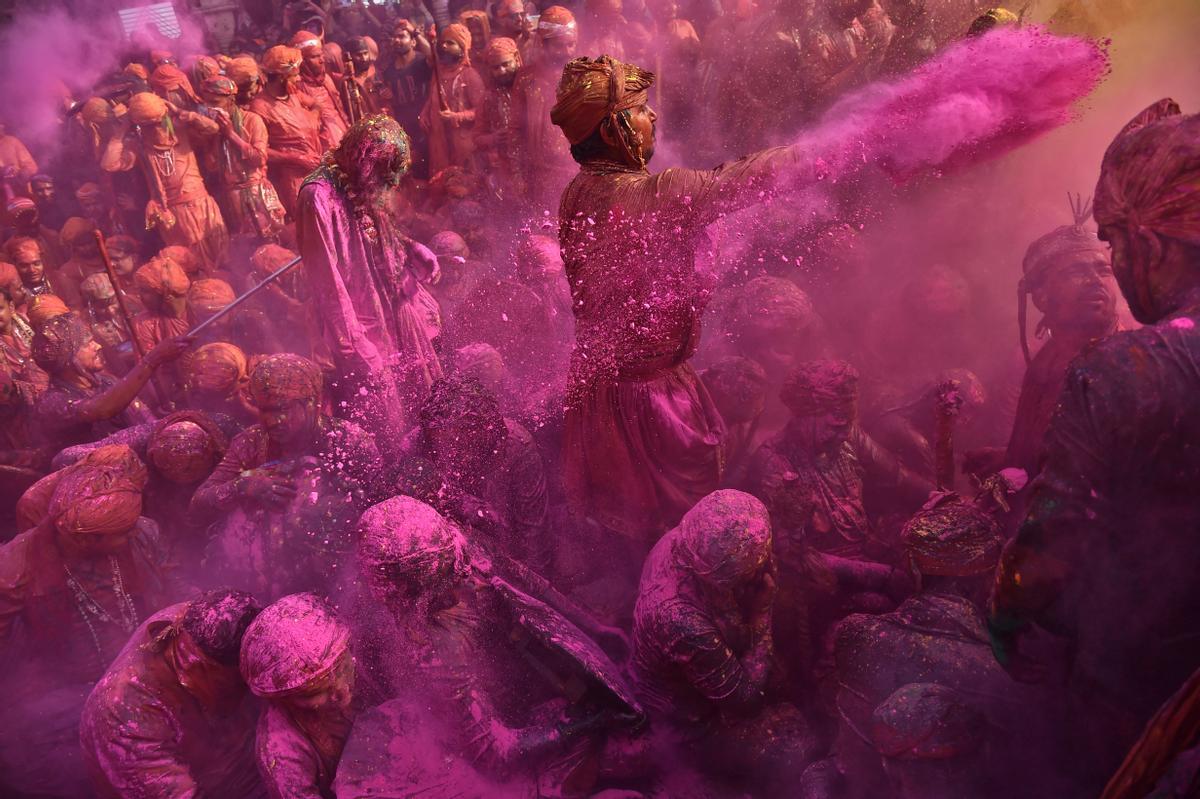 Los devotos hindúes participan en el festival religioso de Holi dentro de un templo en la aldea de Nandgaon, en el estado de Uttar Pradesh, India.