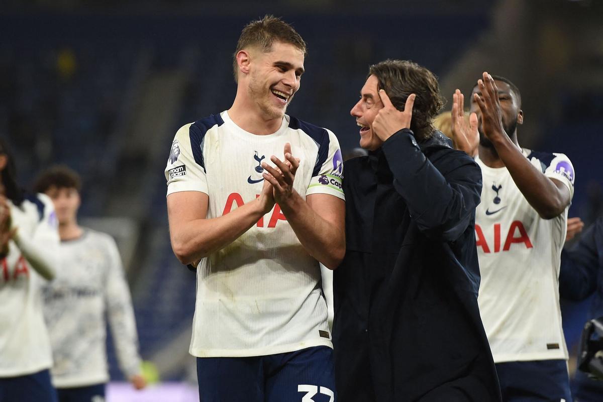 Tottenham Hotspur's Dutch defender #37 Micky van de Ven (L) and Tottenham Hotspur's Danish head coach Thomas Frank (R) celebrate on the pitch after the English Premier League football match between Everton and Tottenham Hotspur at Hill Dickinson Stadium in Liverpool, north west England on October 26, 2025. Spurs won the game 3-0. (Photo by PETER POWELL / AFP) / RESTRICTED TO EDITORIAL USE. No use with unauthorized audio, video, data, fixture lists, club/league logos or 'live' services. Online in-match use limited to 120 images. An additional 40 images may be used in extra time. No video emulation. Social media in-match use limited to 120 images. An additional 40 images may be used in extra time. No use in betting publications, games or single club/league/player publications. /. SEE CAPTION FOR MORE INFORMATION / RESTRICTED TO EDITORIAL USE. No use with unauthorized audio, video, data, fixture lists, club/league logos or 'live' services. Online in-match use limited to 120 images. An additional 40 images may be used in extra time.