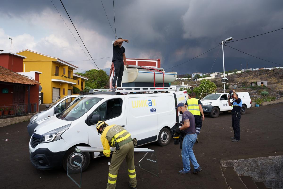 Vecinos sacan enseres de un negocio de Todoque.