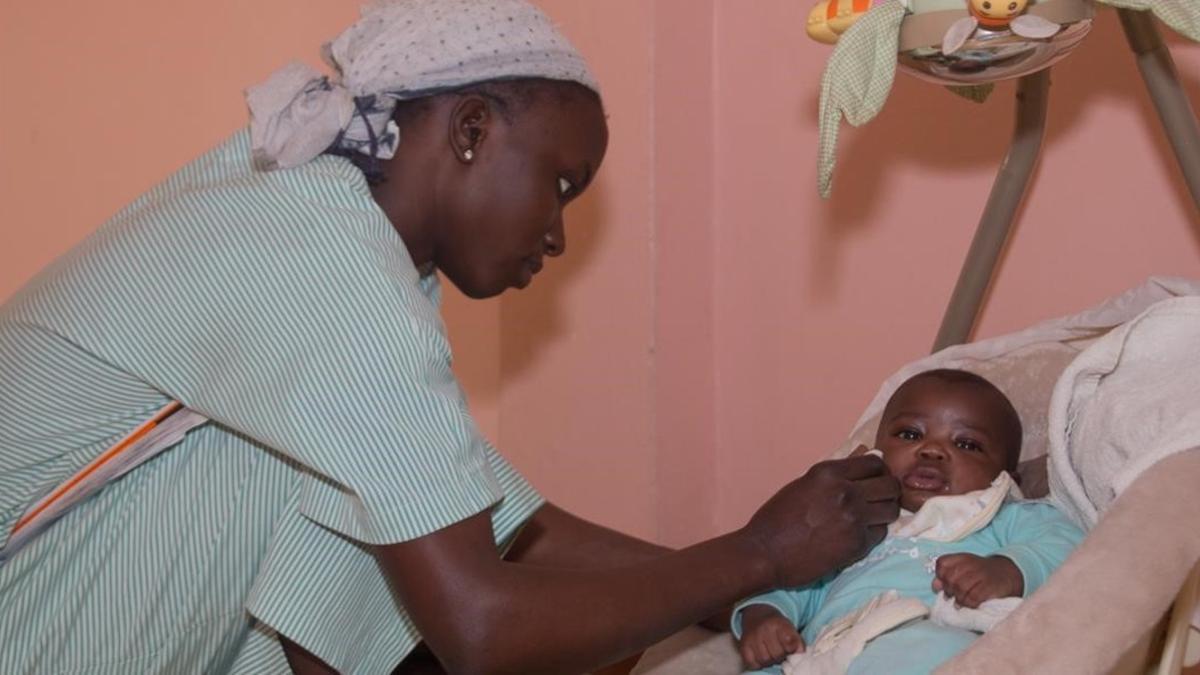 Una mujer cuida a un bebé en Senegal en el refugio de las Hermanas Franciscanas.