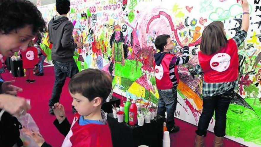 Algunos de los niños que ayer llenaron Laboral Centro de Arte, realizando un gran mural.