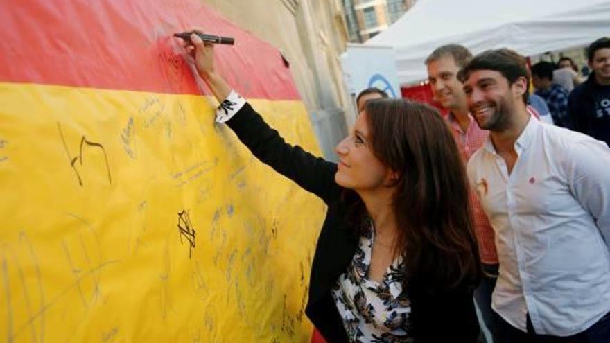Andrea Levy, signant la bandera espanyola, en un acte per la unitat d&#039;Espanya, ahir a Astúries.