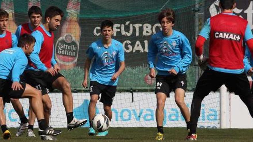Varios jugadores del filial y el juvenil A, junto a Toni y Bellvís, durante el entrenamiento de ayer en A Madroa. // Ricardo Grobas