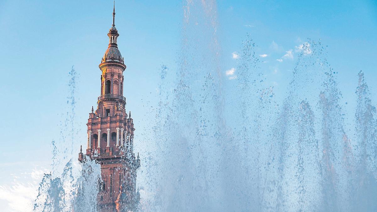 Water from a fountain bubbling in front of one of the towers of the Plaza de España in Seville (panoramic view)