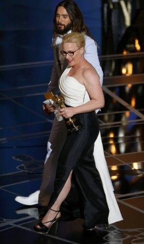 Patricia Arquette walks off the stage with presenter Jared Leto after winning the Oscar for Best Supporting Actress for her role in "Boyhood" at the 87th Academy Awards in Hollywood, California