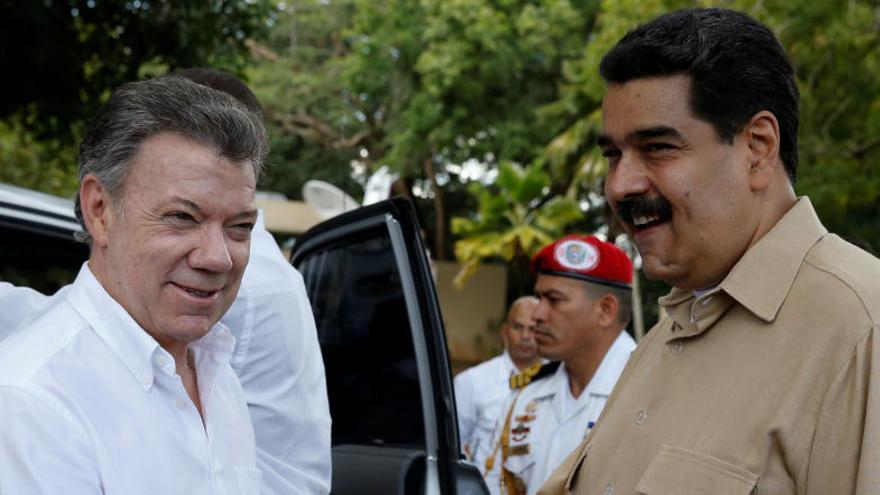 Santos y Maduro sellan el acuerdo con un apretón de manos.