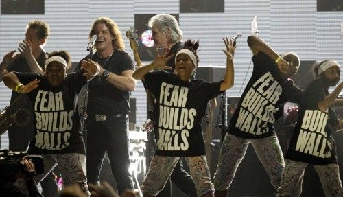 Dancers perform with Rogers Waters during the "12-12-12" benefit concert for victims of Superstorm Sandy at Madison Square Garden in New York