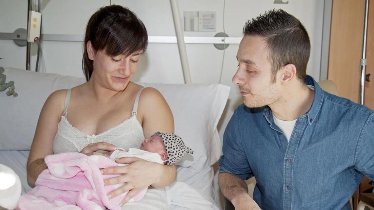 El primer catalán del año, Lara, junto con sus padres, este domingo, en el hospital de Santa Caterina de Salt.