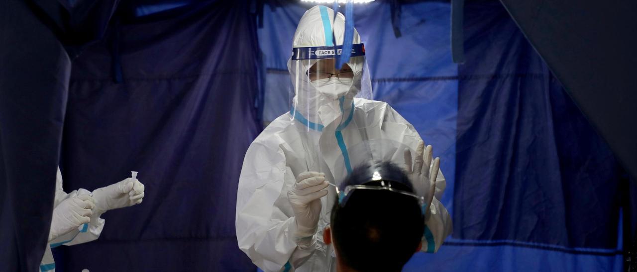 A doctor collects a swab sample from a man at a testing station of Clinic 365, amid the coronavirus disease (COVID-19) outbreak in Kuala Lumpur