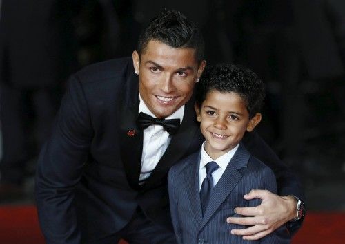 Soccer player Ronaldo and his son Ronaldo Jr. pose for photographers on the red carpet at the world premiere of "Ronaldo" at Leicester Square in London