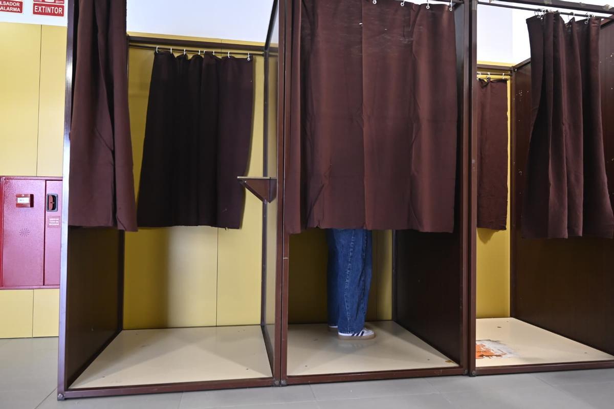 Un elector, dentro de una cabina de votación, este domingo en las elecciones de Aragón.