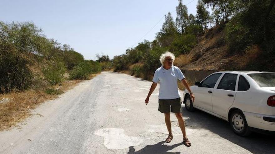 José Aguilar, presidente de la asociación de vecinos La Presa, en el Camino del Mallorquín repleto de baches.