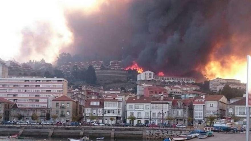 Las llamas cercan viviendas en Baiona.