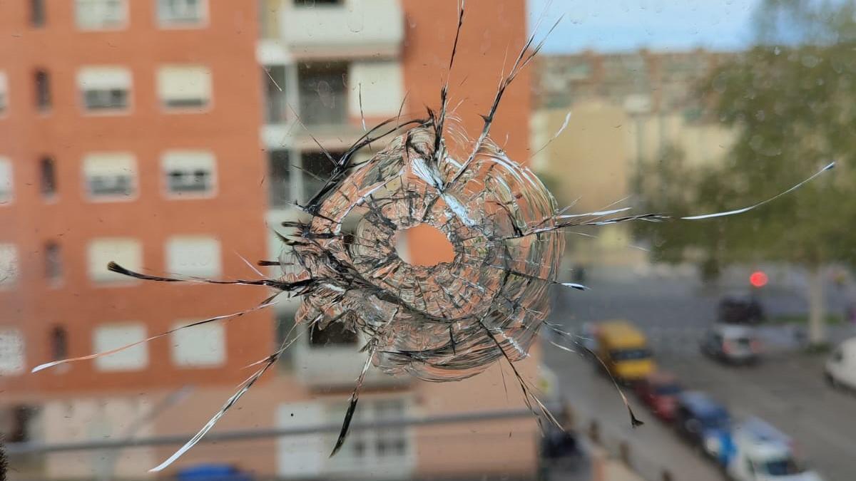 Orificio causado en la ventana de un piso del Besòs por una bala perdida durante un tiroteo.