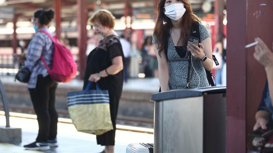 Una persona con mascarilla en el andén de la estación de tren de Chamartín.