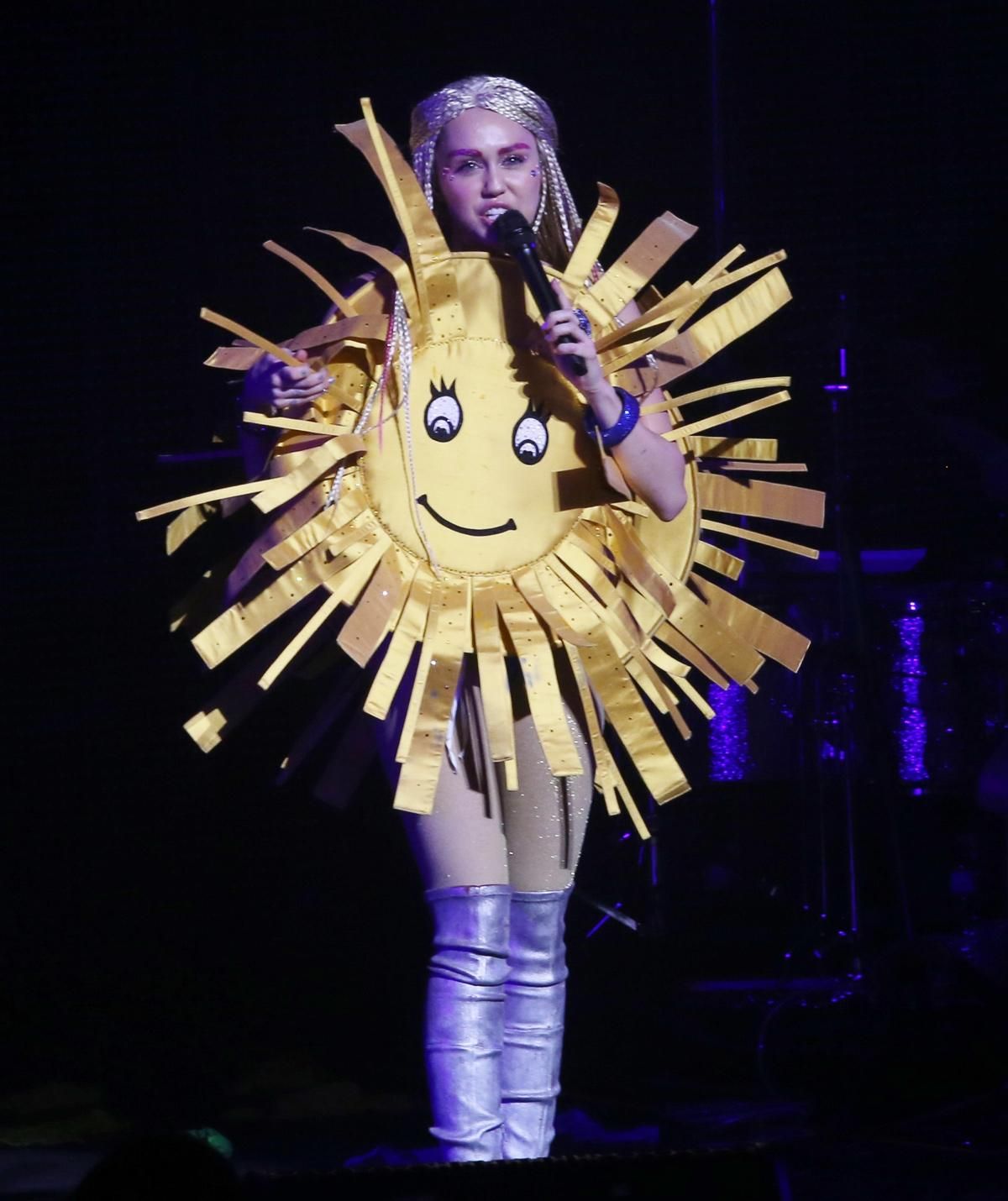 Miley Cyrus en el concierto con un disfraz de sol