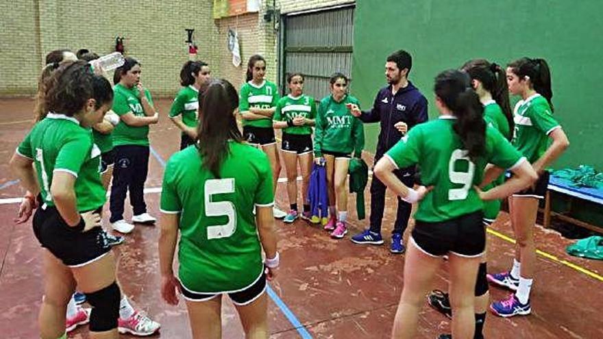 Las jugadoras del Ángel Óptico atienden a su entrenador durante un tiempo muerto.